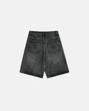 Faded black knee-length denim jorts with wide-leg fit