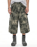 Wide-leg camo longline shorts with faded wash and relaxed streetwear fit